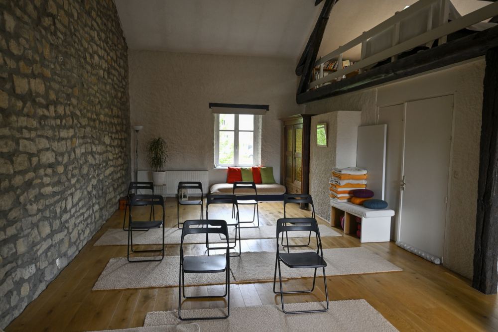 La salle d'activités, son mur de pierre, son parquet et la mezzanine sous les poutres